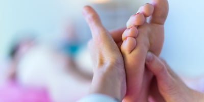 a person holding their hands up to their feet