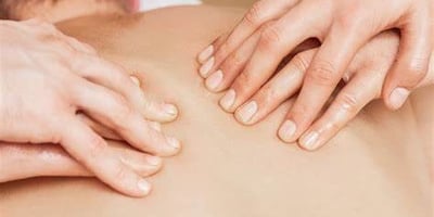 a man is shown with hands on his back