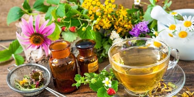 a cup of tea and a teapot with flowers