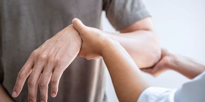 a man holding a woman's hand while she is holding her hand