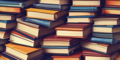 A collection of books neatly arranged on a shelf, featuring titles focused on mindfulness, happiness, and science. The spines display various colors and fonts, reflecting a diverse selection of subjects and authors.