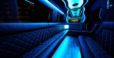The inside of a party bus with blue neon