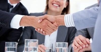 a business meeting with a handshake of two people