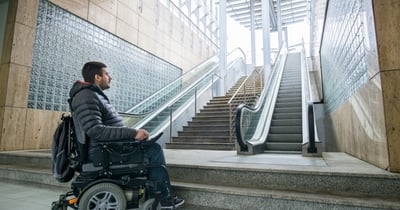 Man in Powerchair Looks Up at Inaccessible Steps