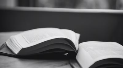 Black and white image of a book on a table