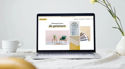 a laptop computer screen displaying a websitepage with a picture of a desk with a
