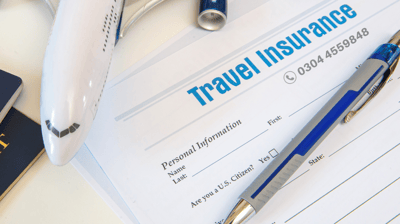 a pen on travel insurance paper