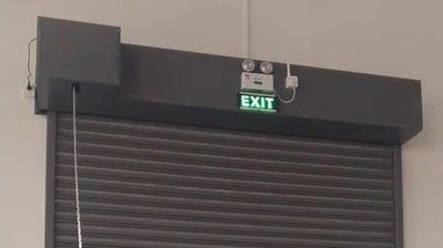 a garage door with a exit sign and exit sign