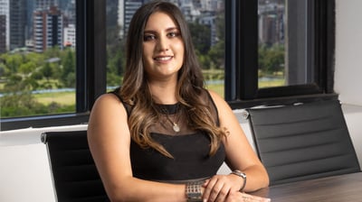 Retrato corporativo de joven mujer abogada con cabello rubio posando de forma profesional en una sala de reuniones