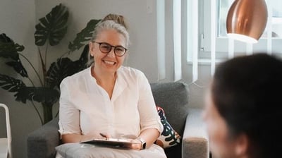 a woman sitting on a couch in a living room
