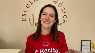 a woman in a red shirt and white shorts