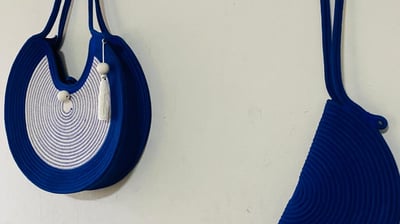 two blue purses with a white and silver purse