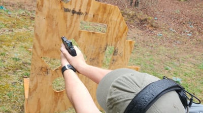 Man using Self-defense firearm from behind a barrier on training range.