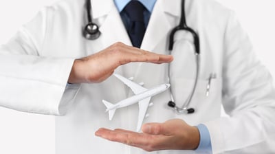 a doctor holding a plane model of a plane