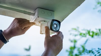 residential or commercial security camera being assembled or maintained