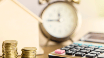 a house with a calculator and coins