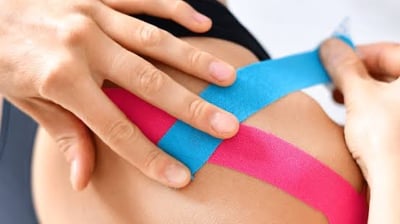Kinesiology taping for sports injury recovery by physiotherapist