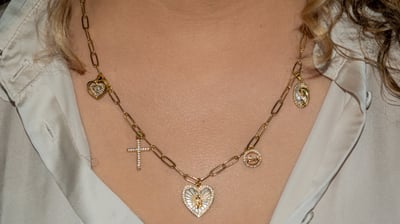 a woman wearing a necklace with a cross on it