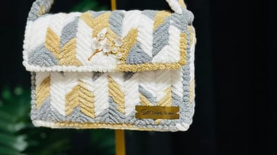 a small purse bag with a yellow and white chevrons