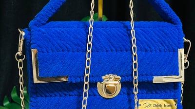 a blue purse with chain link and chain link