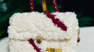 a white purse with a red and white purse