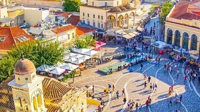 a city square with a lot of people walking around