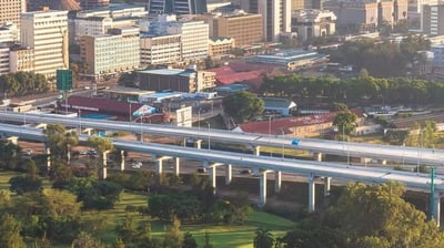 a city skyline view of a bridge over a river