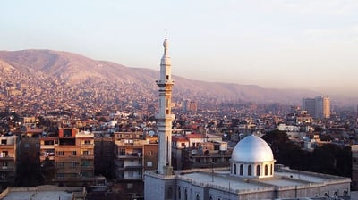 a mosque with a dome shaped building in the background
