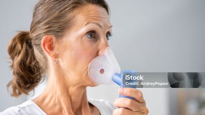 a woman with a breathing mask on her nose and nose mask