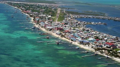a large body of water with a small town in the background