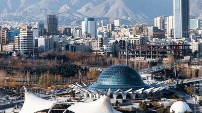 a city skyline with a large building in the background