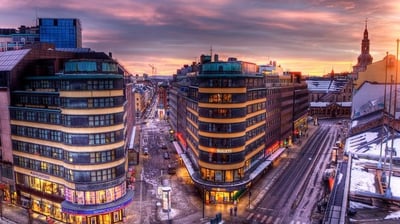 a city street scene with a train on the tracks