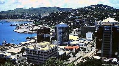a city view of a city with a view of a harbor and mountains
