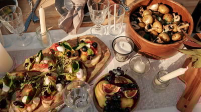a table with a bowl of fruit and a bowl of fruit