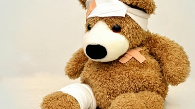 a teddy bear with bandages and bandages on it