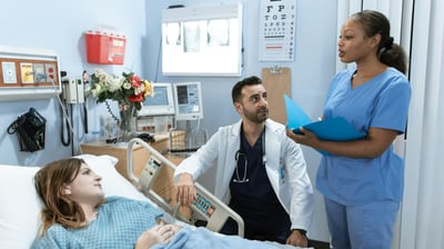a nurse and a patient in a hospital room