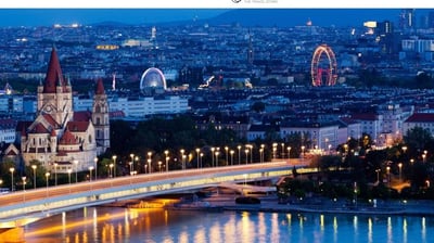 a bridge over a river with a ferris wheel
