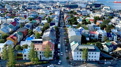 a city street with a lot of buildings and a lot of people