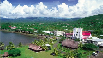 a church with a large church in the background