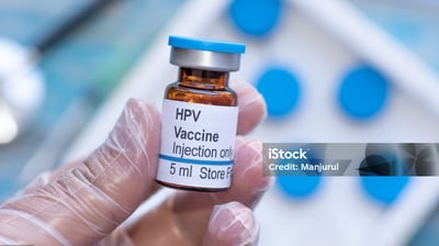 a person holding a bottle of vaccine vaccine