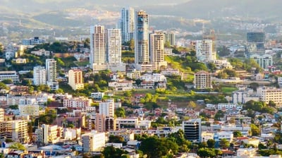 a city skyline view of a city with a mountain in the background