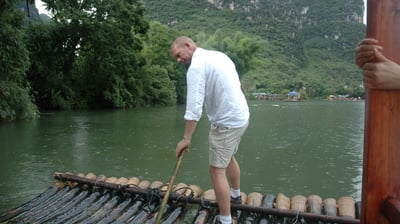 Nick Billington driving the raft at the Yulonghe scenic area, near Yangsh