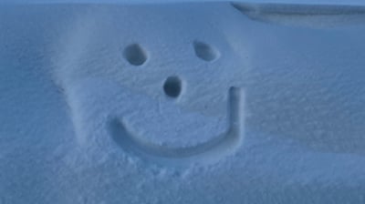 a face in the snow outside the airport, reykjavik, Iceland