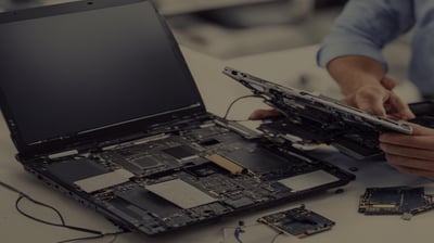 a man is holding a laptop computer and a laptop