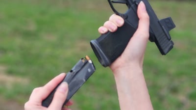 Women reloading defensive firearm.
