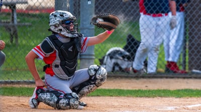 a catcher is holding a baseball glove