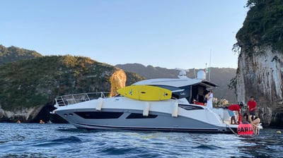 a boat with a yellow surfboard on the water