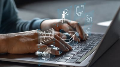 a person using a laptop computer with a laptop on the table