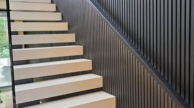 Modern floating staircase design with vertical slat wall feature in a luxury Vancouver home