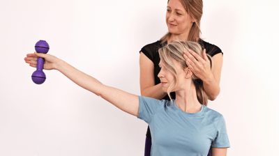 a woman is holding a purple object in her hand